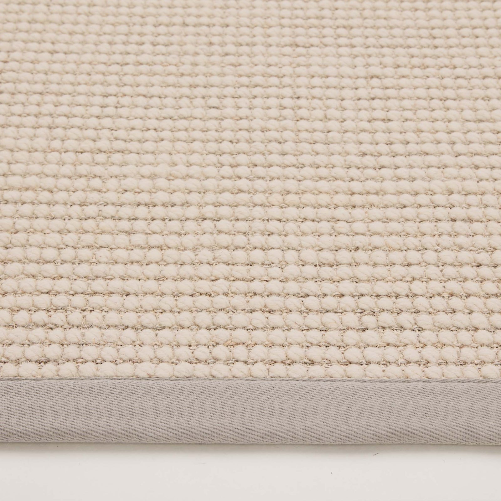 Sisal Boucle Grey Rug made from 100% wool with a solid grey border. 