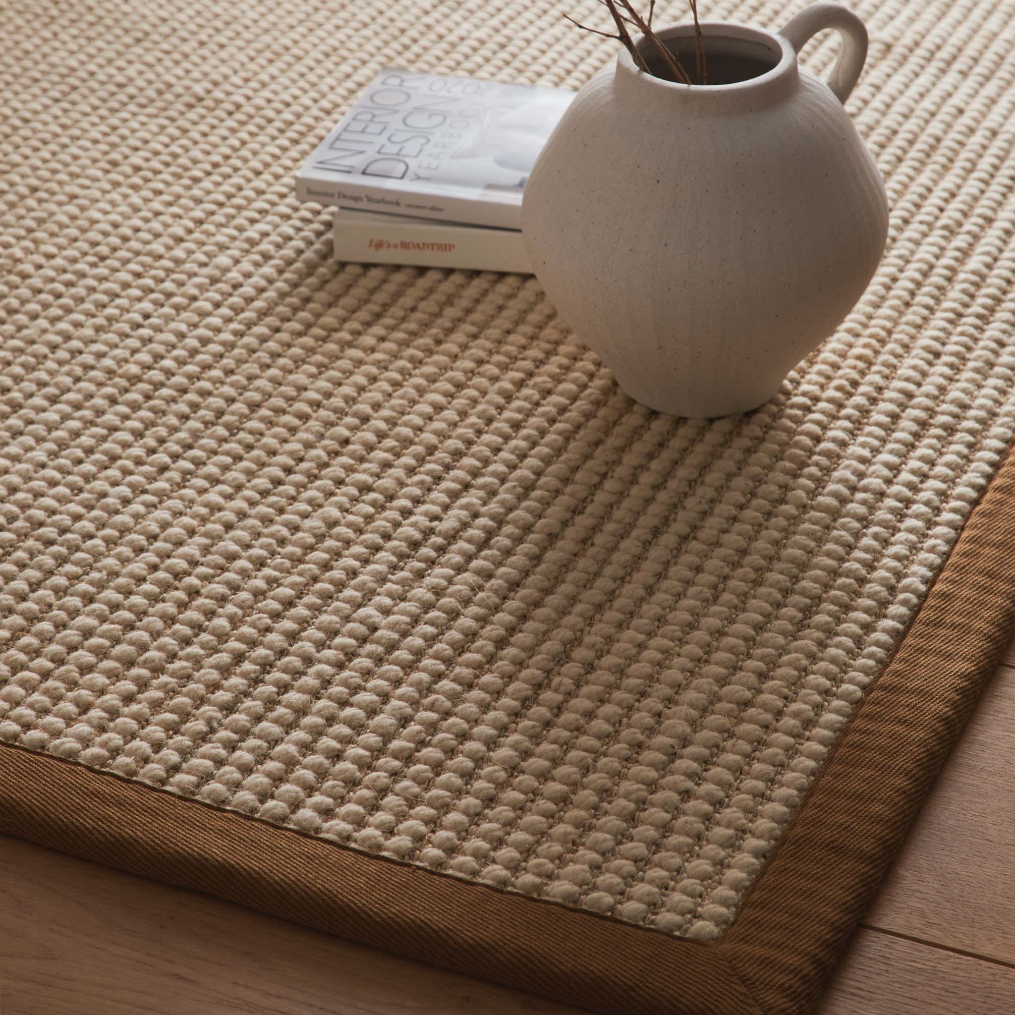 Sisal Boucle Mocha Rug made from 100% wool with a solid brown border. 