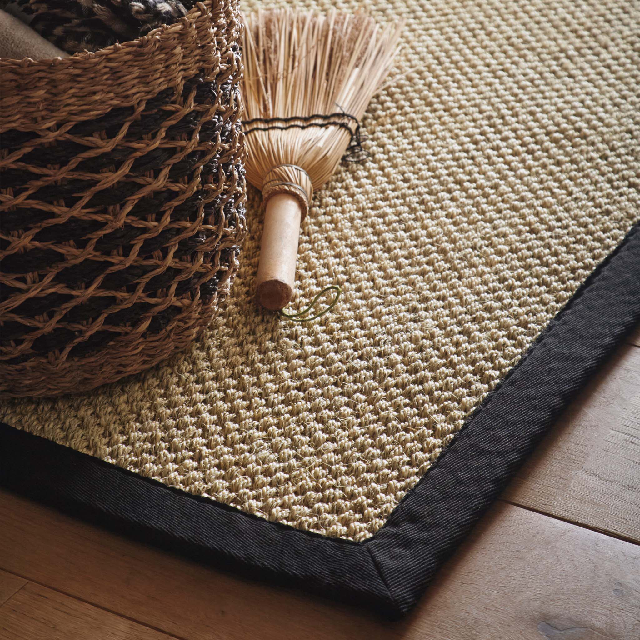 Sisal Light Beige With Black Border Runner  with a natural centre and a black border, styled on wooden flooring. 