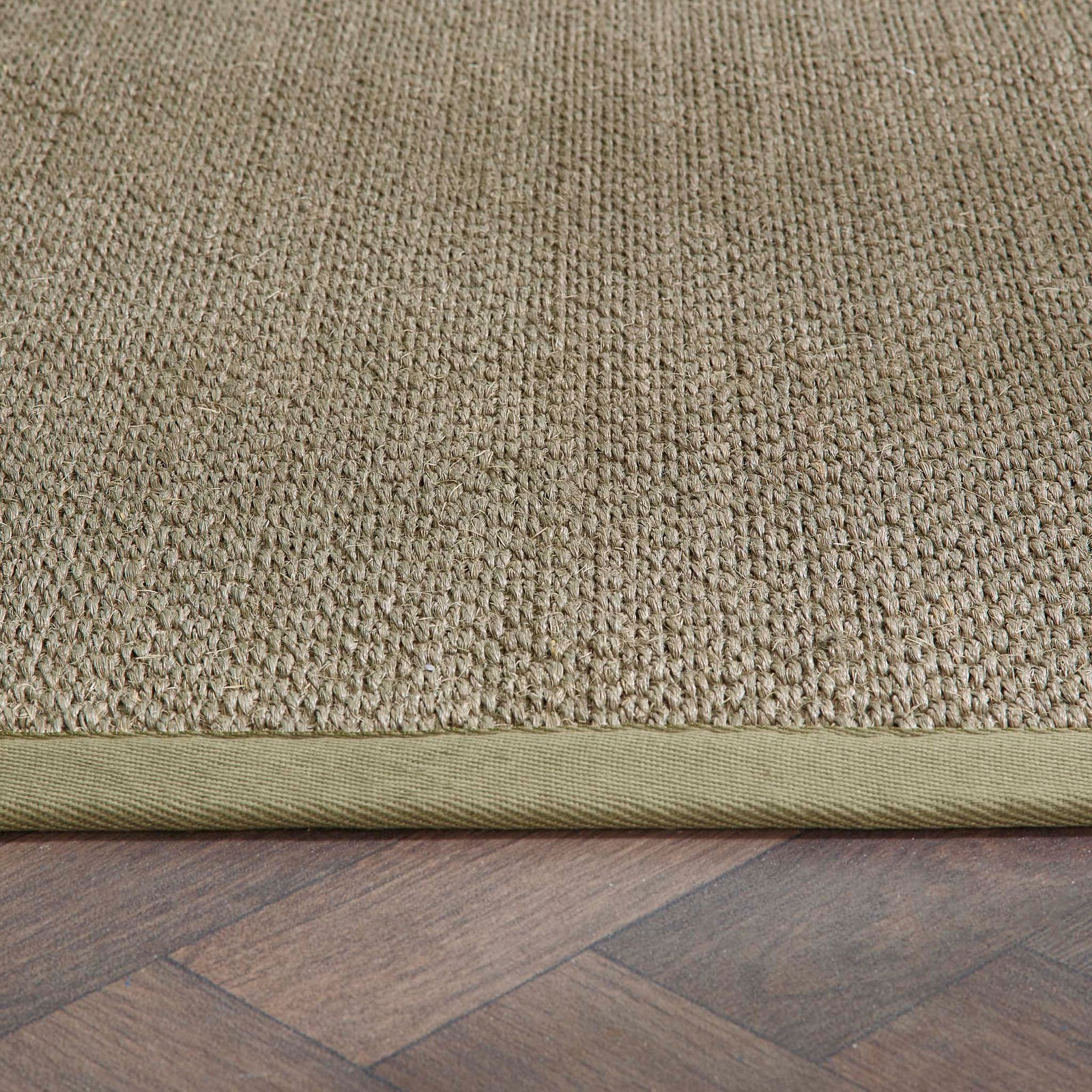 Close-up of Sisal Green with Sage Green Border Runner showing pile height, green border, and a textured centre. 