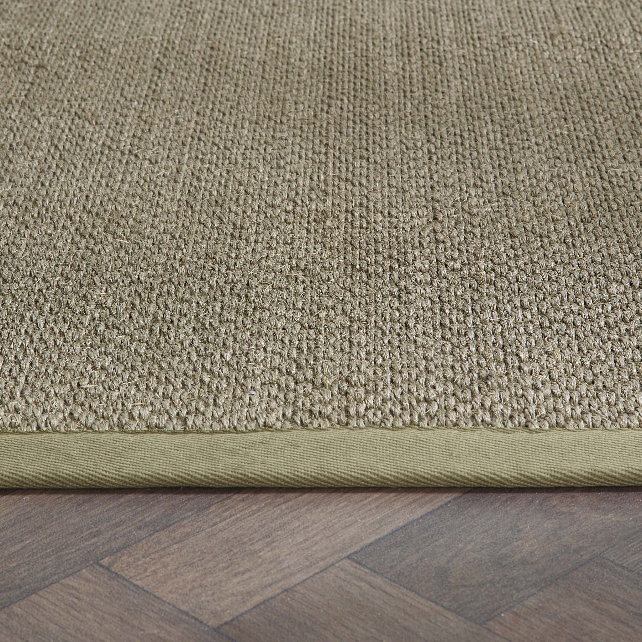 Close-up of Sisal Green with Sage Green Border Runner showing pile height, green border, and a textured centre. 