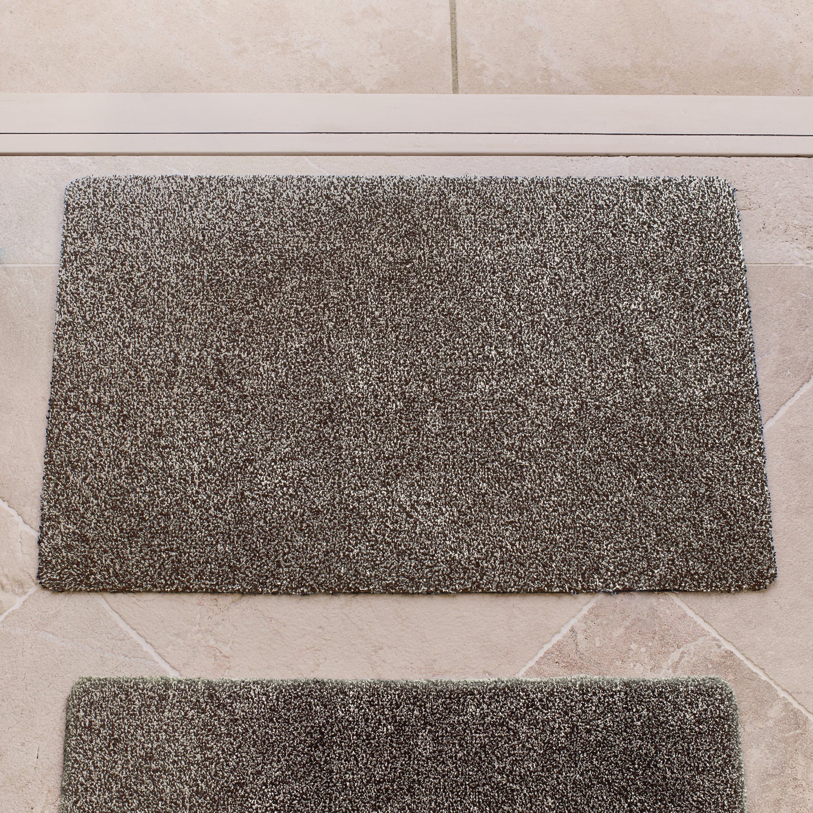 Plain Fleck Slate Doormat with a grey fleck design, styled in a doorway.