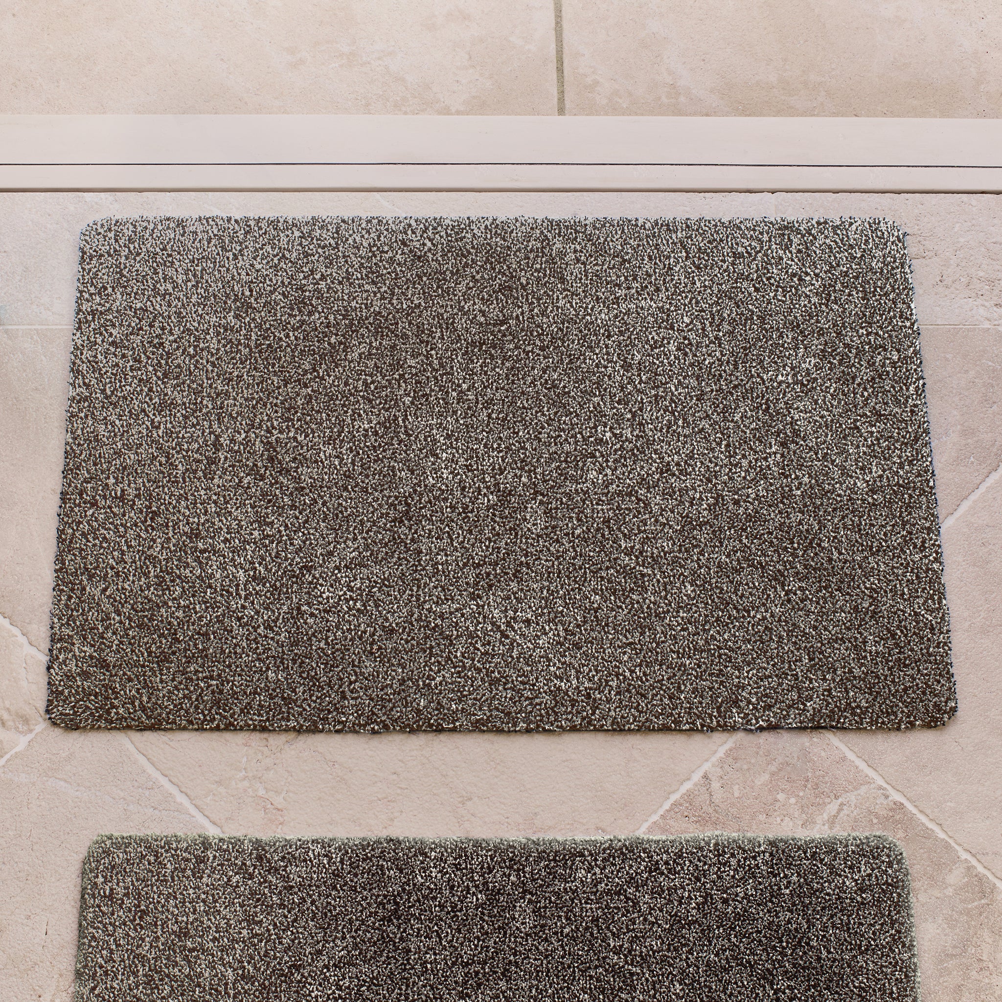 Plain Fleck Slate Doormat with a grey fleck design, styled in a doorway.