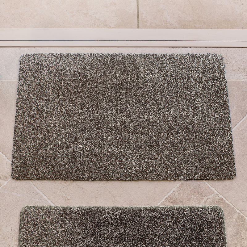 Plain Fleck Slate Doormat with a grey fleck design, styled in a doorway.