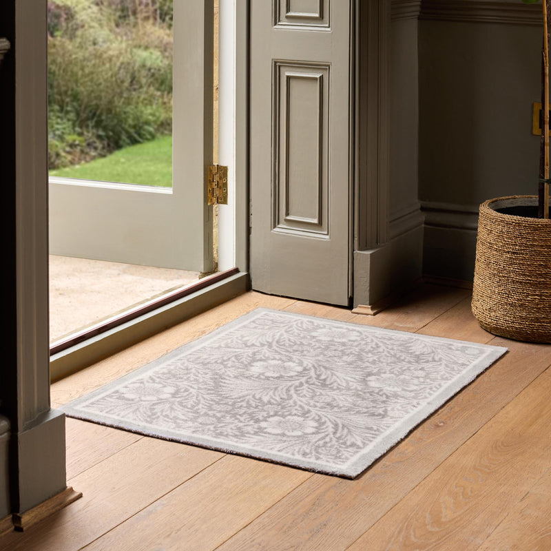 Soft Florals Grey Doormat with a floral design, styled in a entryway.