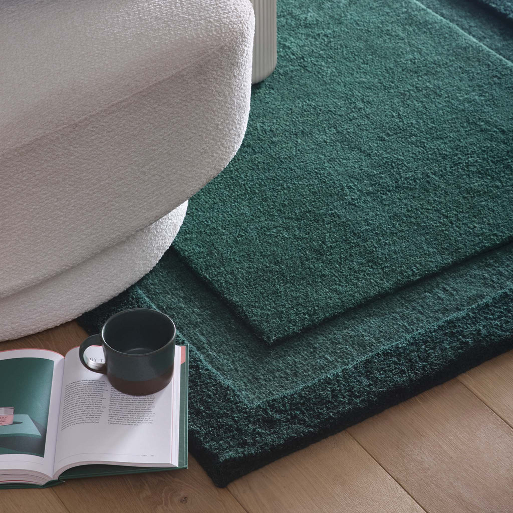 Stacked Borders Evening Blue Rug- a 100% two toned wool rug in dark green.
