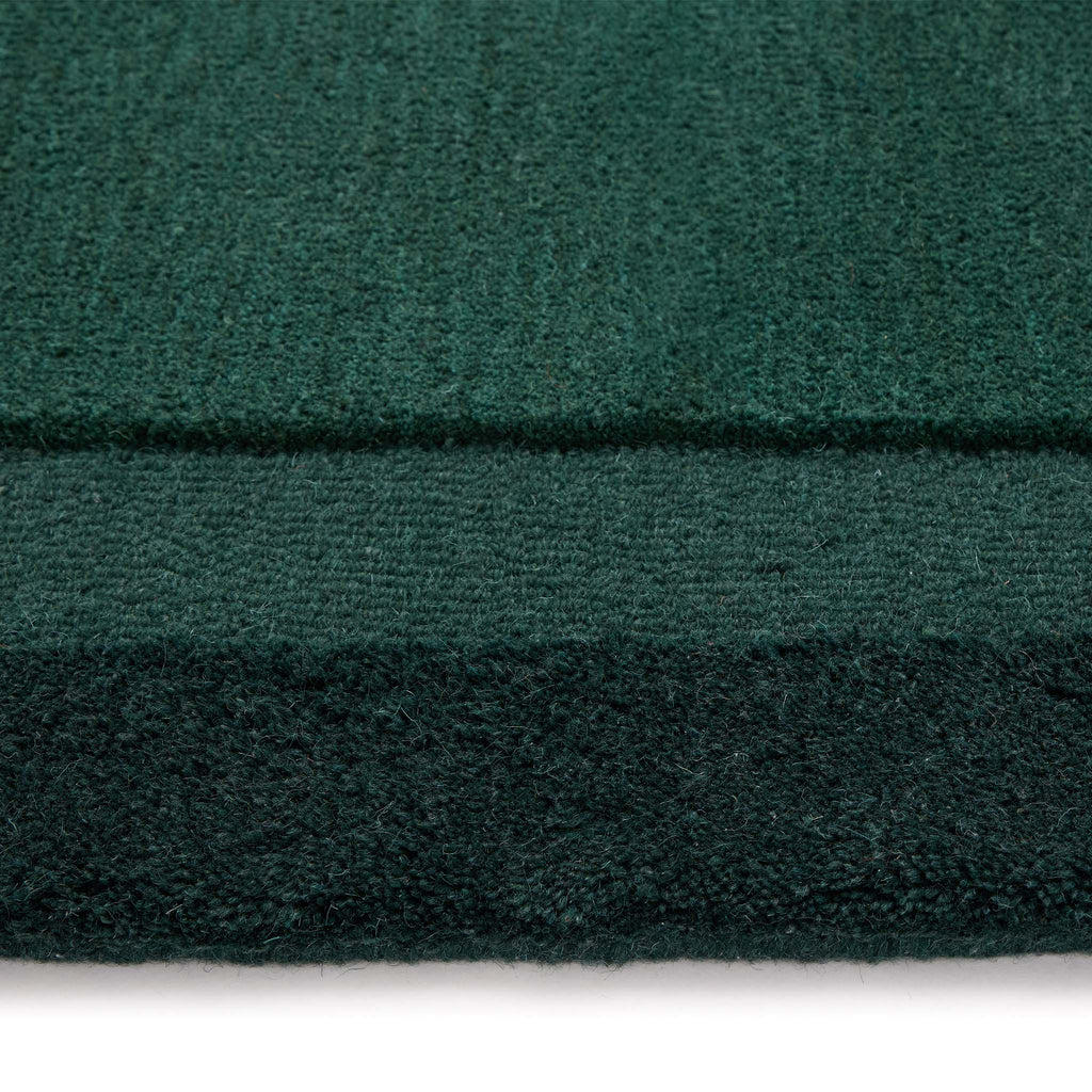 Stacked Borders Evening Blue Rug- a 100% two toned wool rug in dark green.