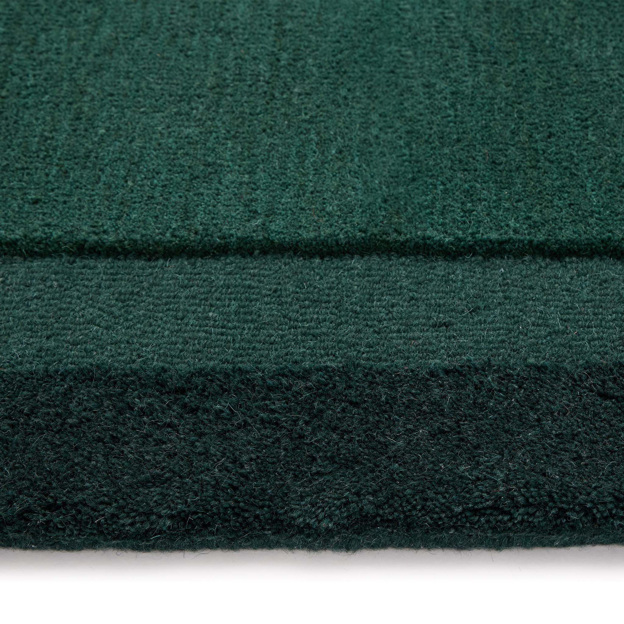 Stacked Borders Evening Blue Rug- a 100% two toned wool rug in dark green.