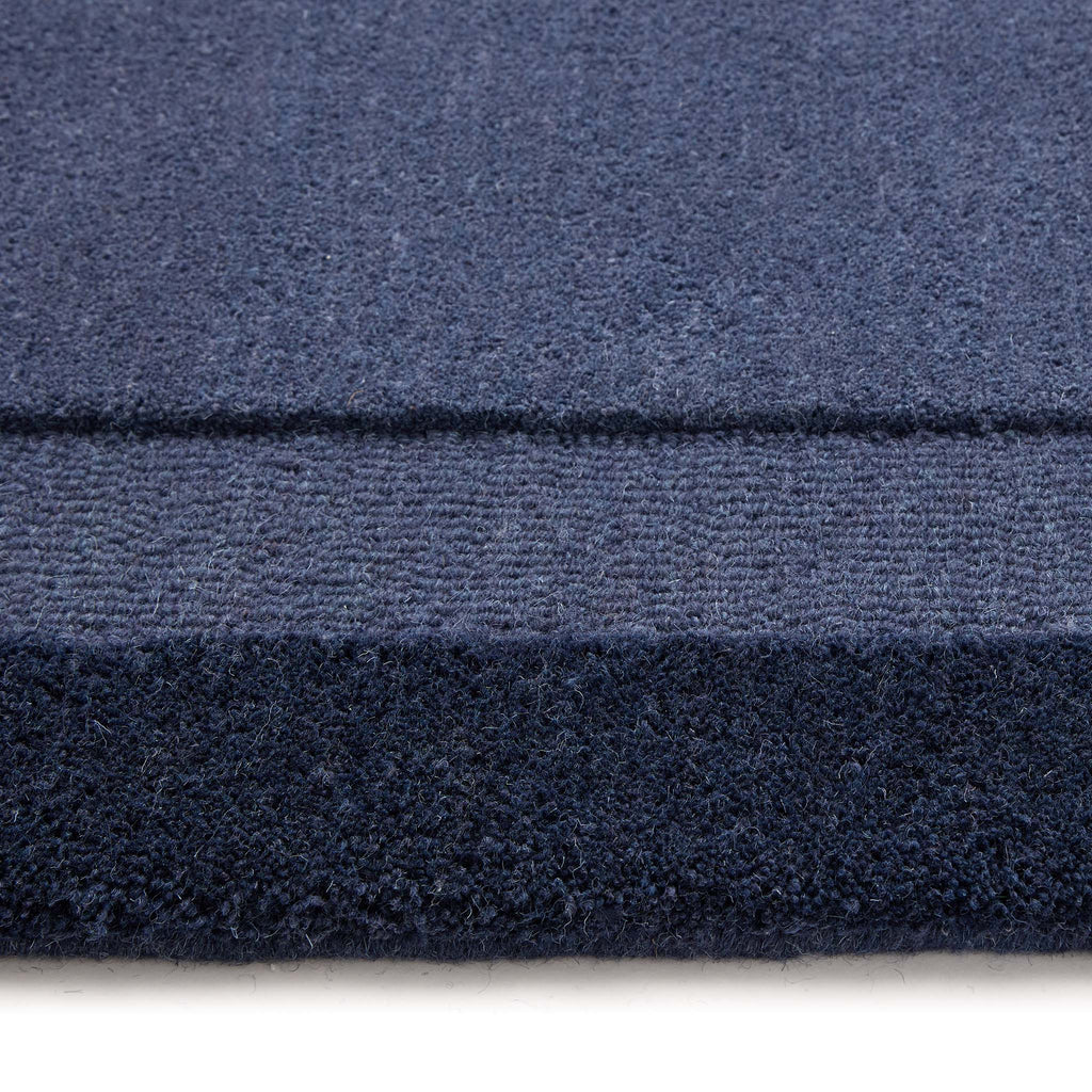 Stacked Borders Evening Blue Rug- a two toned 100% wool rug in blue.