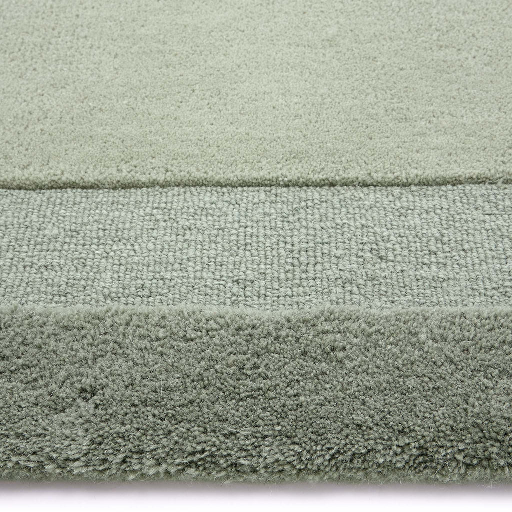 Stacked Borders Soft Green Rug. Made from 100% wool featuring a border design.
