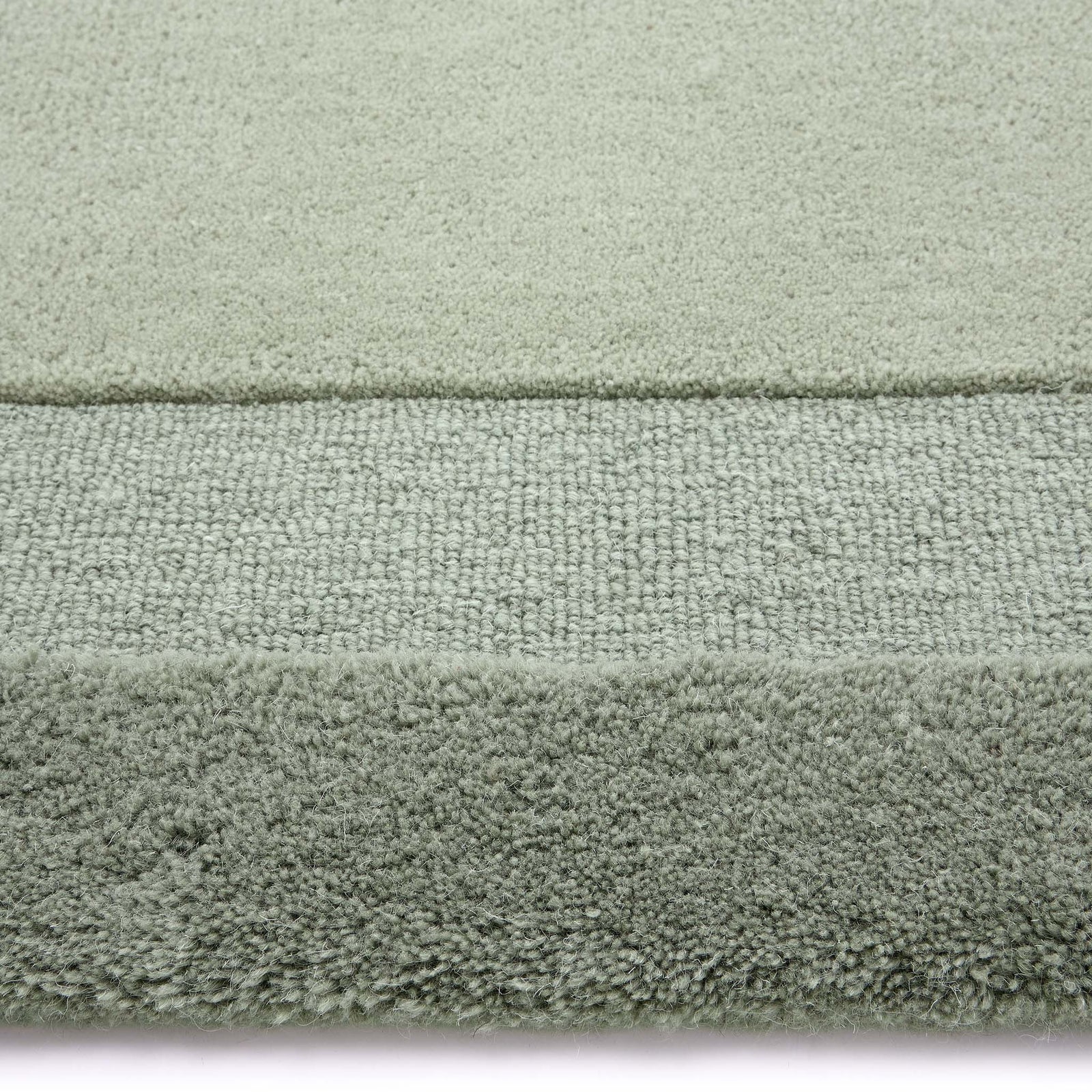 Stacked Borders Soft Green Rug. Made from 100% wool featuring a border design.