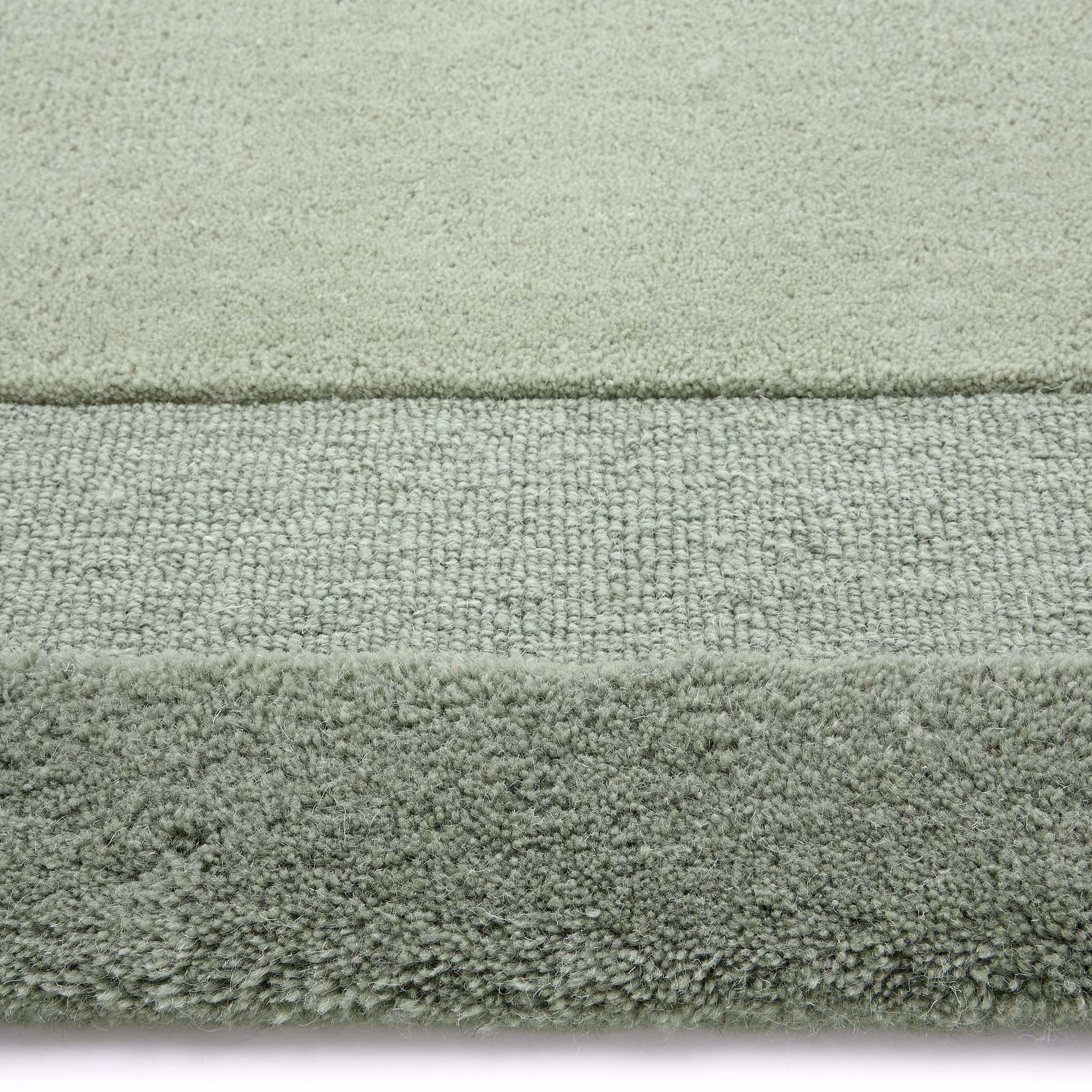 Stacked Borders Soft Green Rug. Made from 100% wool featuring a border design.