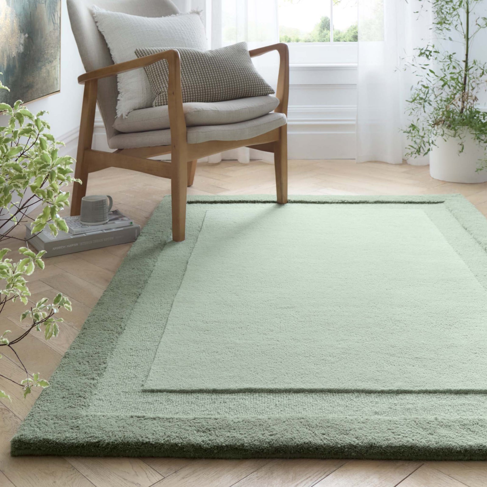Stacked Borders Soft Green Rug. Made from 100% wool featuring a border design.