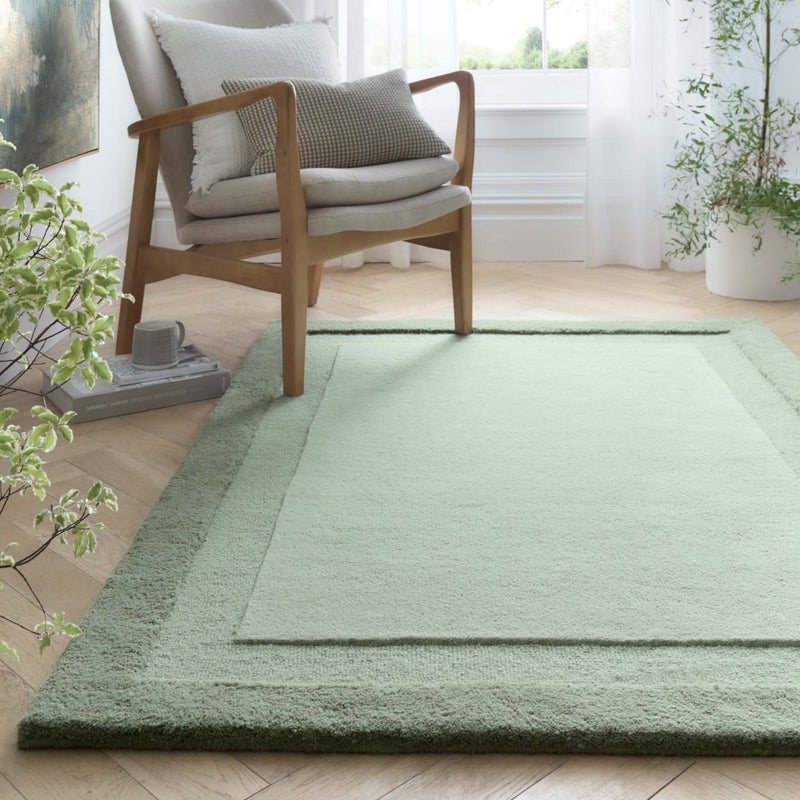 Stacked Borders Soft Green Rug. Made from 100% wool featuring a border design.