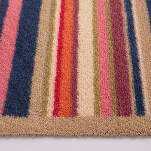 Sunset Stripe Washable Doormat- a wool washable doormat featuring a cheerful mix of stripes in pink, green, white , orange ,blue and purple. 
