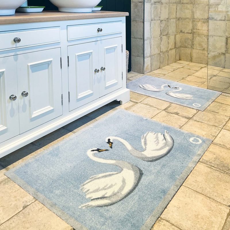 Swan 1 Bath Mat made from 100% recycled materials, featuring two white swans. 