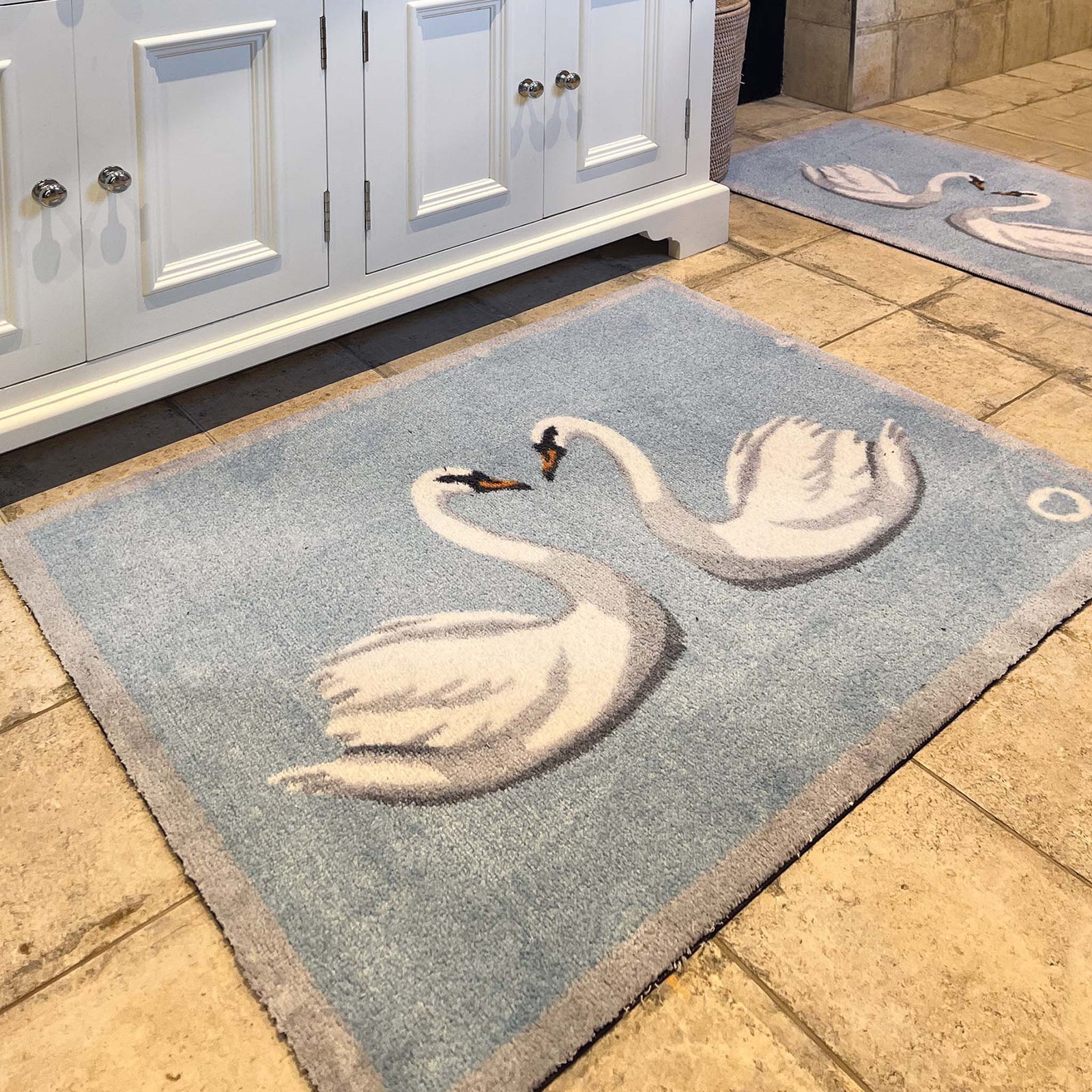 Swan 1 Bath Mat made from 100% recycled materials, featuring two white swans. 