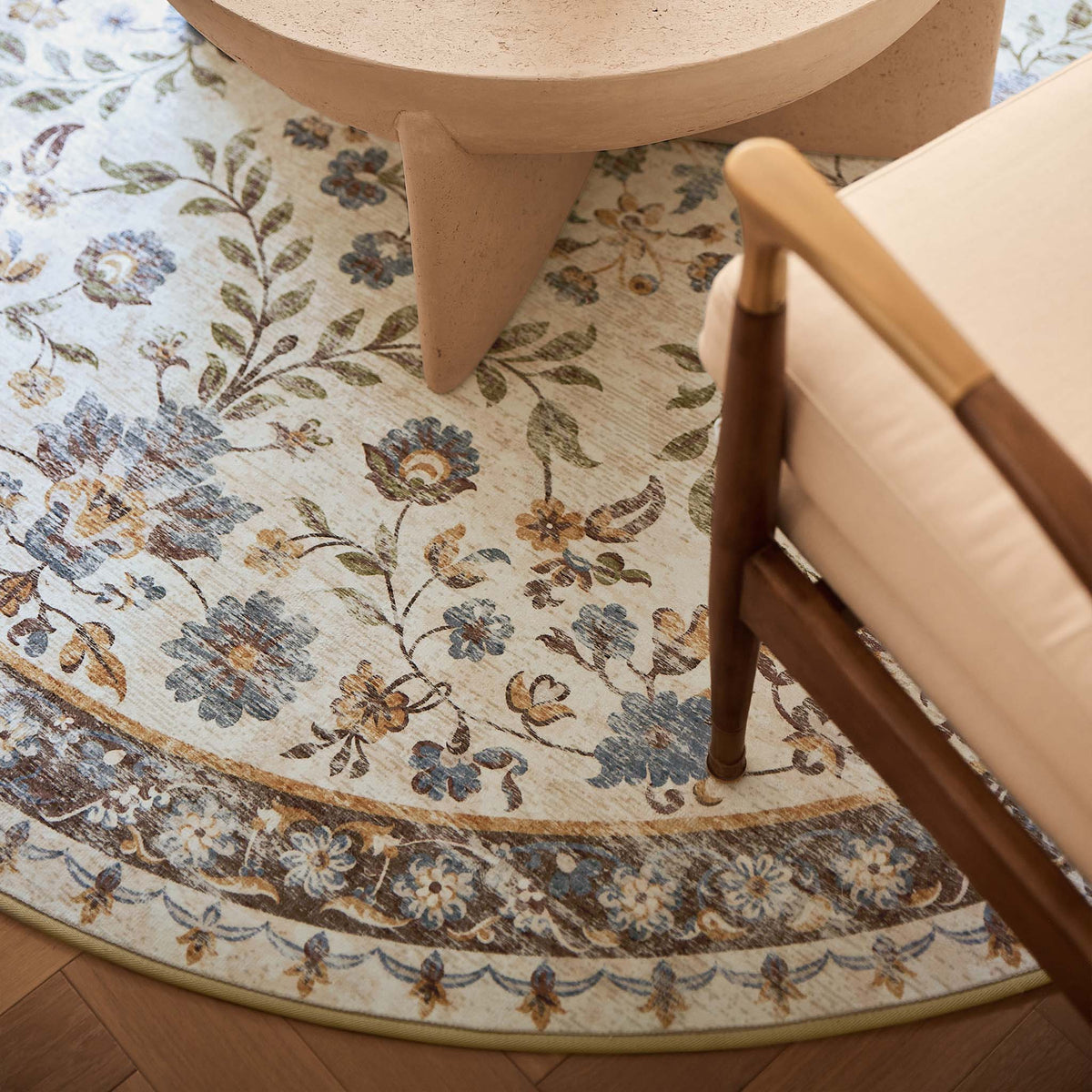 Close-up of Cottage Garden Eco-Washable Circle Rug with a floral design, styled on wooden flooring.