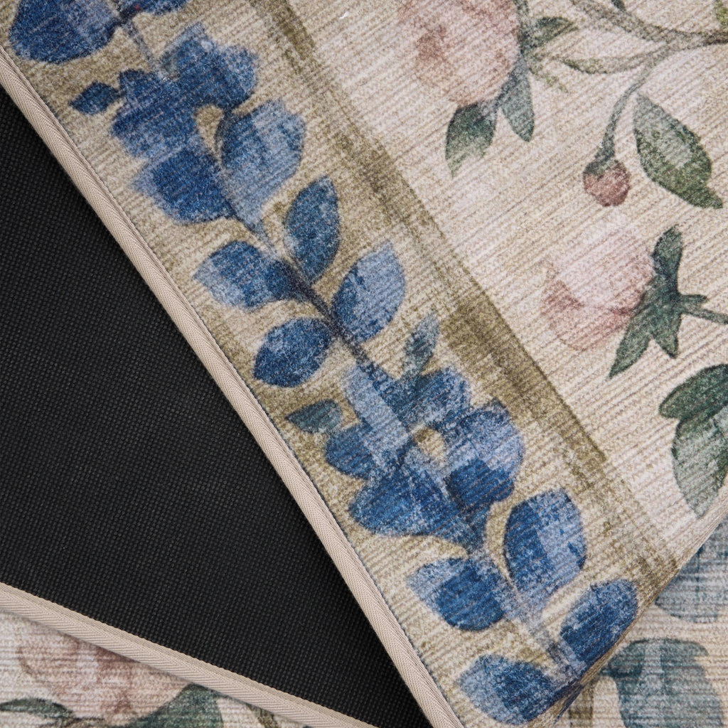 The Lady Rose Eco-Washable Rug - a beige and green eco-washable rug featuring blue and pink florals and green leaves.