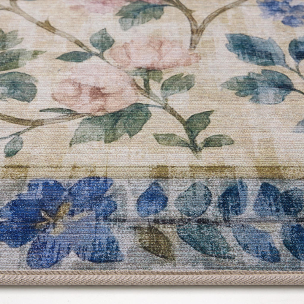 The Lady Rose Eco-Washable Rug - a beige and green eco-washable rug featuring blue and pink florals and green leaves.