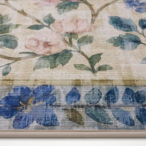 The Lady Rose Eco-Washable Rug - a beige and green eco-washable rug featuring blue and pink florals and green leaves.