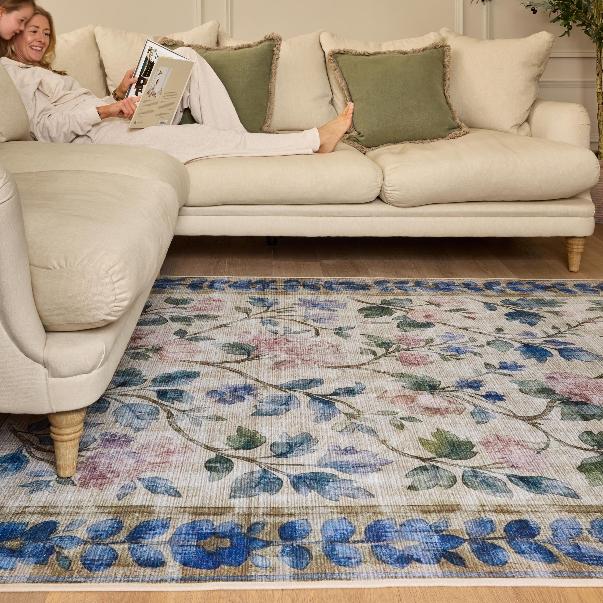 The Lady Rose Eco-Washable Rug - a beige and green eco-washable rug featuring blue and pink florals and green leaves.