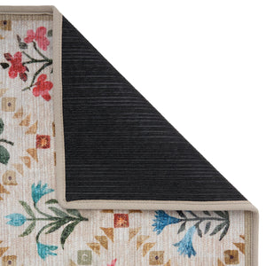 The Wildflower Patch Eco-Washable Rug- a beige eco-washable rug featuring vibrant florals.