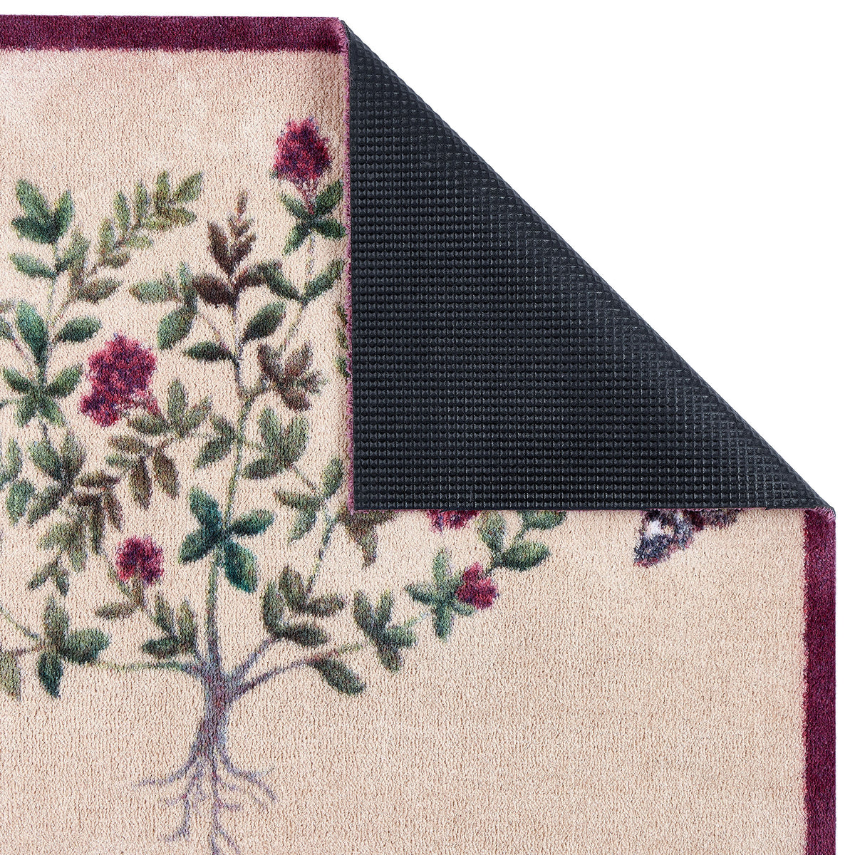 Close-up of Thyme Walk Lichen & Gooseberry Washable Doormat with a purple floral nature inspired pattern showing a rubber backing. 