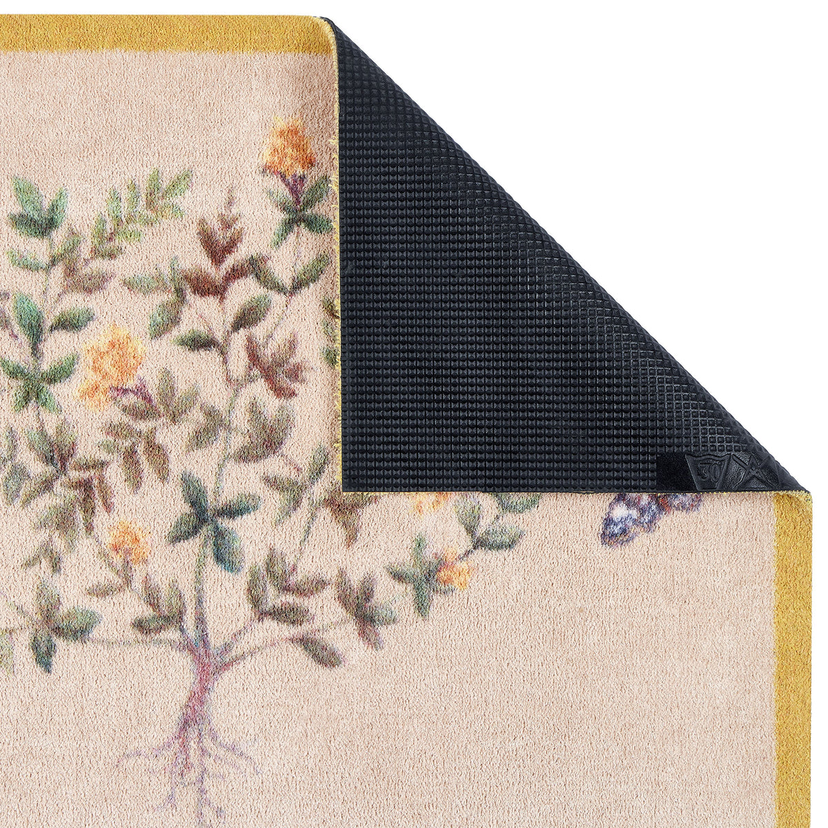 Close-up of Thyme Walk Lichen & Gooseberry Washable Doormat with a yellow floral nature pattern showing rubber backing.