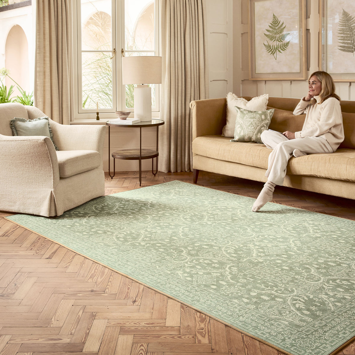 Topiary View Thyme Eco-Washable Rug with a heritage inspired pattern in green, styled in the living room.