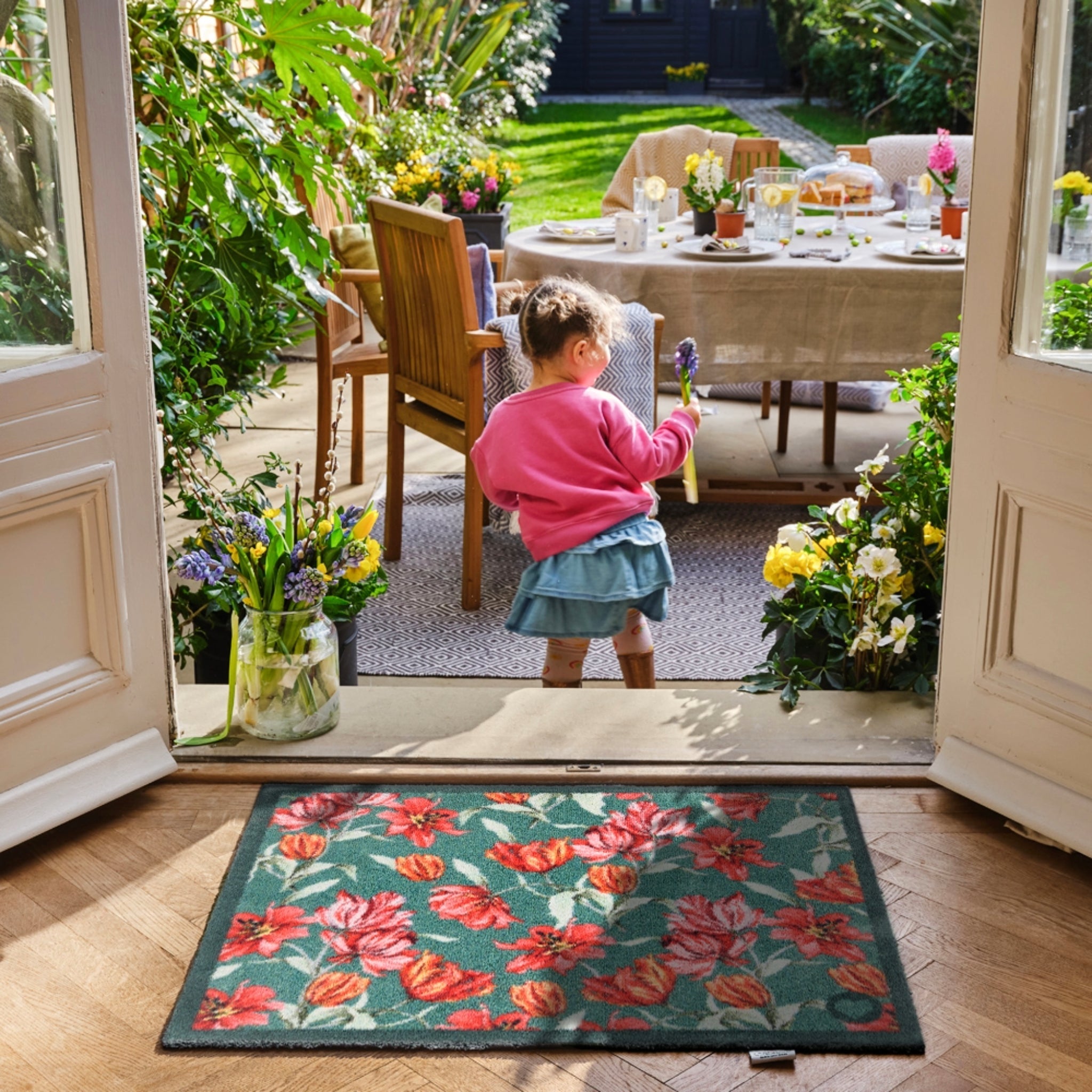 Tumbling Tulips Washable Doormat made from 100% recycled cotton, featuring red and pink tulips.