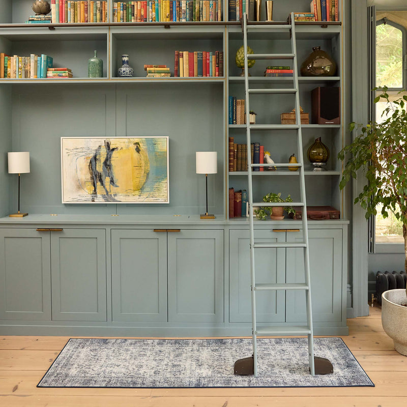Vintage Imperial Grey Blue Eco-Washable Runner with of floral motif in the centre, styled by a bookcase.