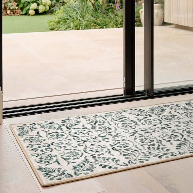 Vintage Scroll Green Eco-Washable Runner with a floral scrolling pattern, styled in a doorway.