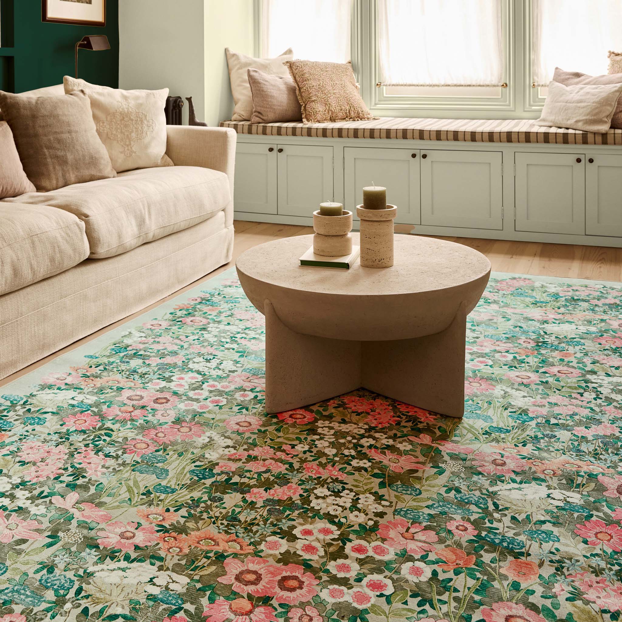 Wallflower Sage Eco-Washbale Rug in Green with a floral design, styled in a living room.