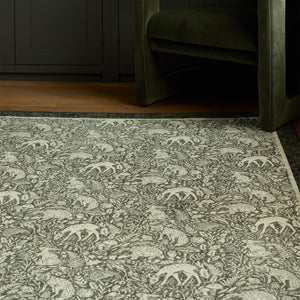 Whimsical Woodland Eco-Washable Rug – a green eco-washable rug featuring white woodland animals and white florals.