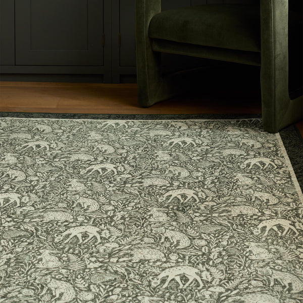 Whimsical Woodland Eco-Washable Rug – a green eco-washable rug featuring white woodland animals and white florals.