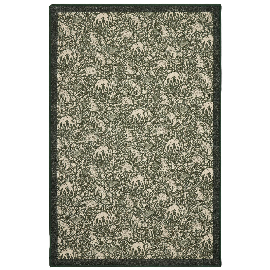 Whimsical Woodland Eco-Washable Rug – a green eco-washable rug featuring white woodland animals and white florals.