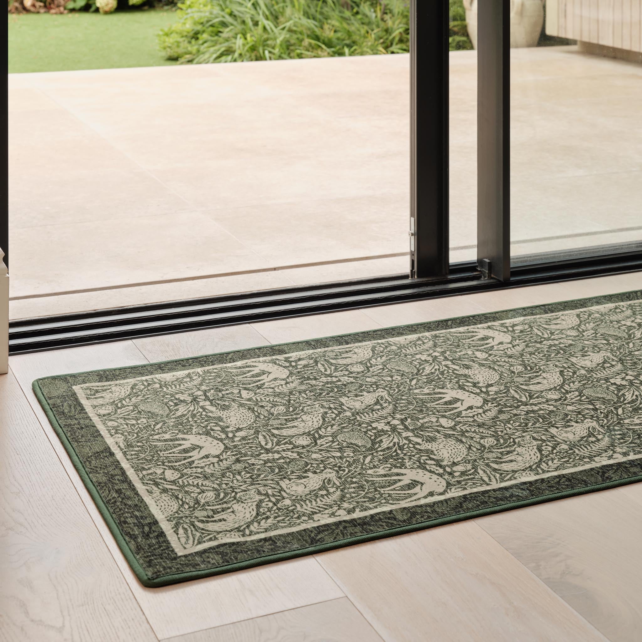 Whimsical Woodland Eco-Washable Runner – a green eco-washable runner featuring white woodland animals and white florals.