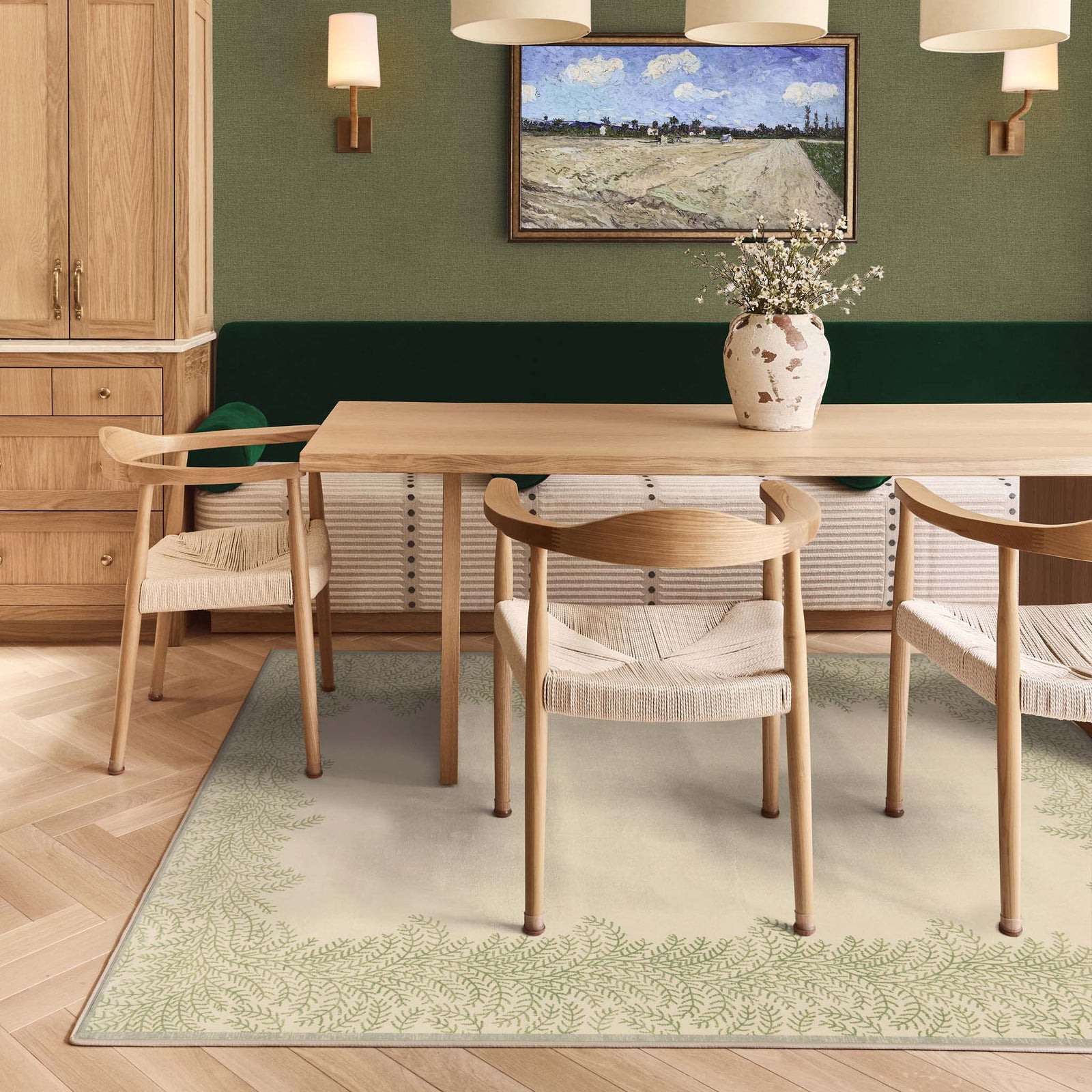 Whispering Fern Parchment Eco-Washable Rug with a fern leaf border design, styled under a kitchen table.