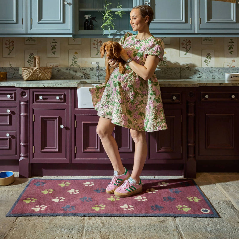  Wipe Your Paws Burgundy Runner in a dark red- a 100% recycled cotton runner featuring scattered paw prints in dark navy, light green, and beige. 