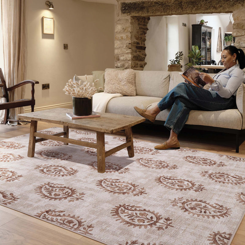 Woodblock Paisley Rust Eco‑Washable Rug with a paisley design, styled in a living room.