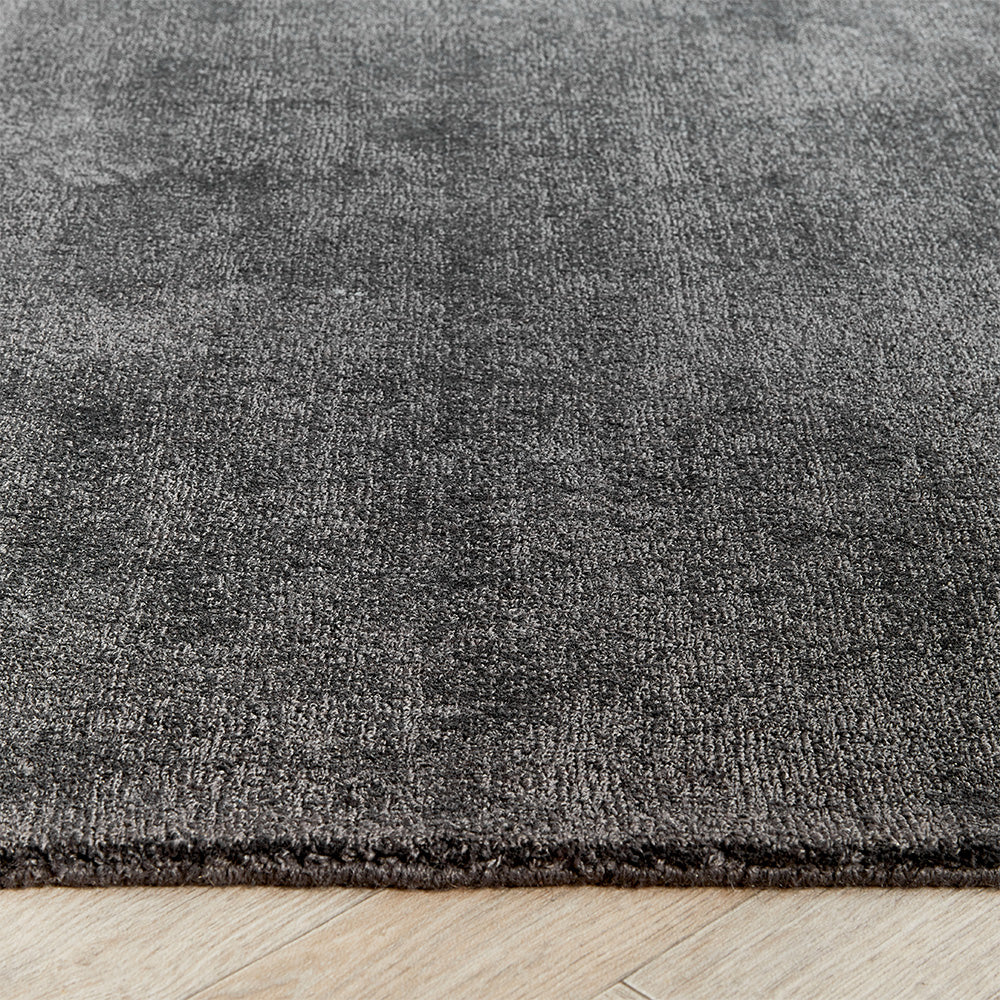 Reef Dark Grey Rug made from 100% recycled materials in a solid dark grey colour. 